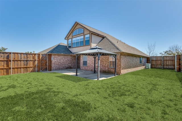 back of house featuring a gazebo, a patio area, a lawn, and brick siding