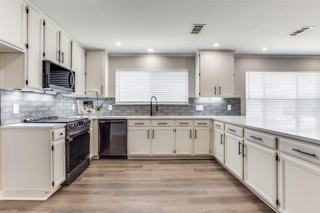 kitchen with visible vents, white cabinetry, range with electric cooktop, and black dishwasher