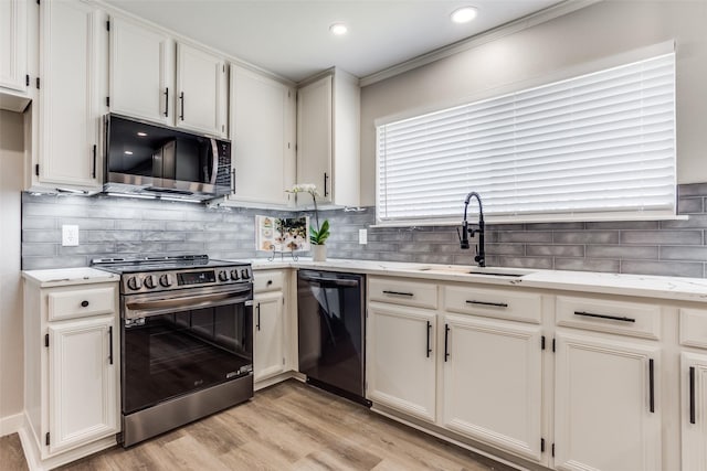 kitchen featuring tasteful backsplash, stainless steel electric range, black dishwasher, and a sink