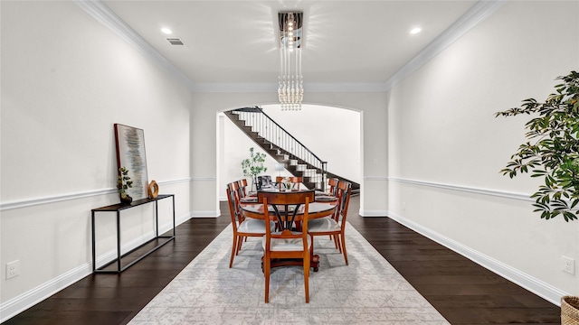 dining room featuring stairway, arched walkways, dark wood-type flooring, and ornamental molding