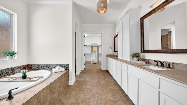 bathroom with crown molding, a garden tub, a sink, and double vanity