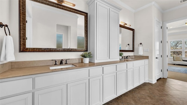 bathroom with crown molding, tile patterned flooring, a sink, and double vanity