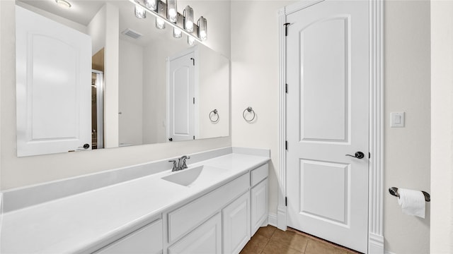 bathroom featuring visible vents, vanity, and tile patterned floors