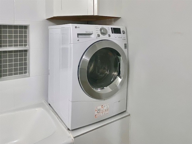 clothes washing area with laundry area and washer / clothes dryer