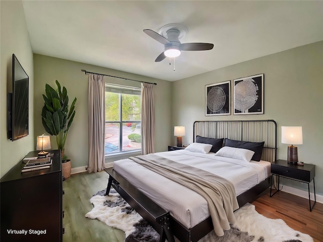 bedroom with baseboards, ceiling fan, and light wood finished floors