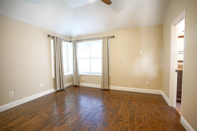 empty room featuring dark wood-style floors, baseboards, and a ceiling fan