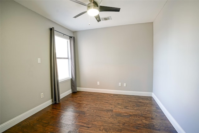 unfurnished room with a ceiling fan, wood finished floors, visible vents, and baseboards