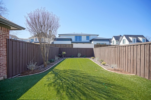 view of yard with a fenced backyard