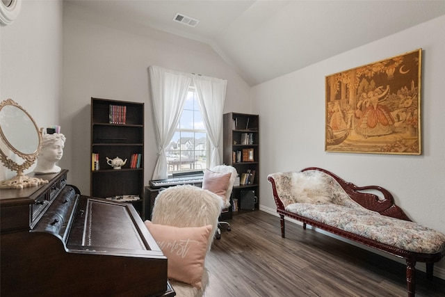 office area featuring visible vents, vaulted ceiling, and wood finished floors