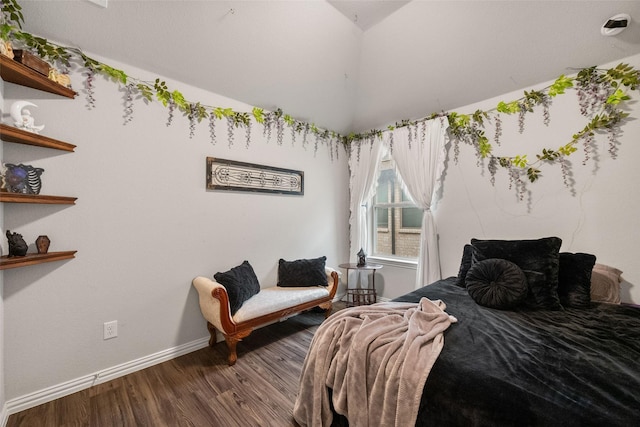 bedroom featuring dark wood-style floors, vaulted ceiling, and baseboards