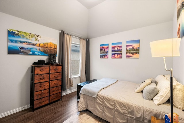 bedroom with lofted ceiling, baseboards, and wood finished floors