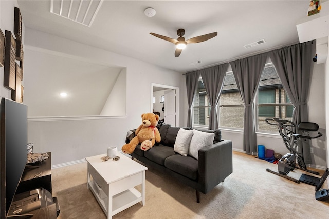 living area featuring carpet floors, ceiling fan, visible vents, and baseboards