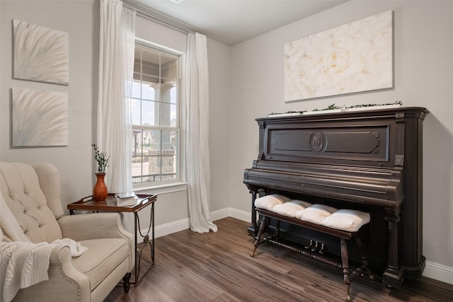 sitting room featuring dark wood-type flooring and baseboards