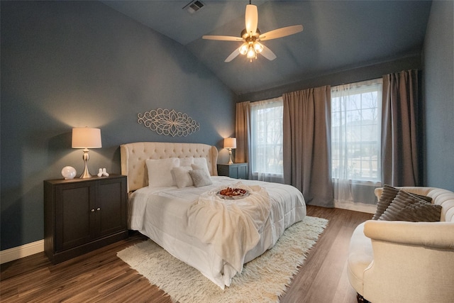 bedroom featuring dark wood finished floors, lofted ceiling, visible vents, ceiling fan, and baseboards