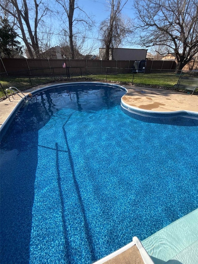 view of swimming pool with a fenced backyard and a fenced in pool