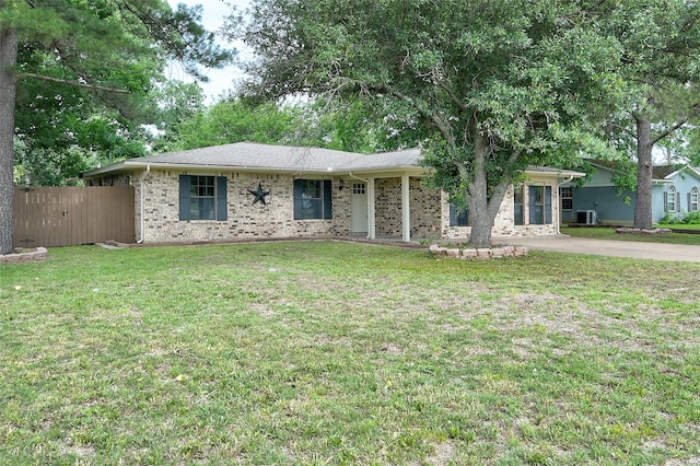 single story home with fence, a front lawn, and brick siding