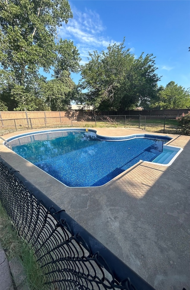 view of swimming pool with a fenced in pool, a fenced backyard, and a patio