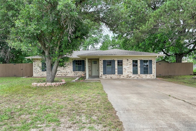 ranch-style house featuring a front lawn, fence, and brick siding