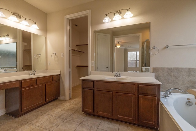 bathroom featuring a sink, two vanities, and tile patterned floors