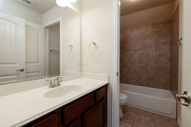 full bathroom with visible vents, toilet, shower / bathtub combination, tile patterned floors, and vanity