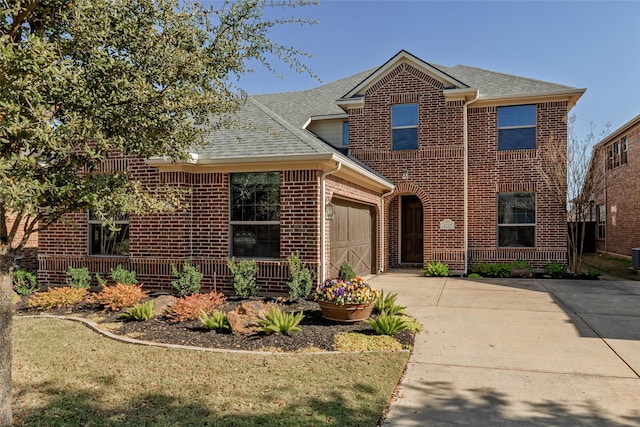 traditional-style house featuring brick siding, driveway, and roof with shingles