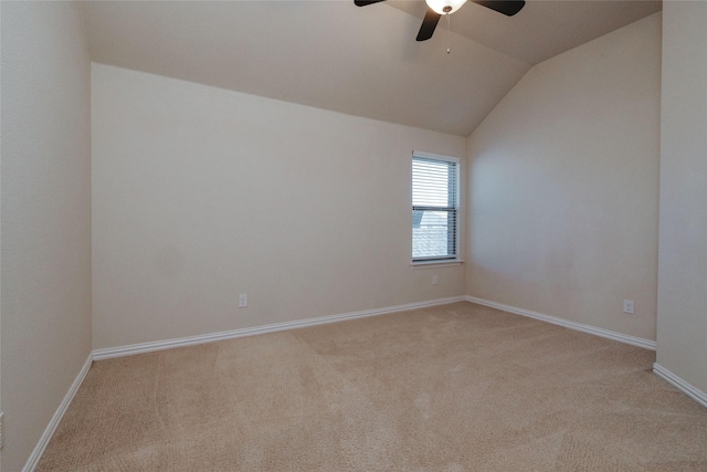 spare room with light carpet, ceiling fan, baseboards, and lofted ceiling