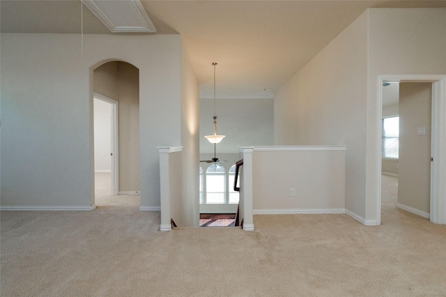 spare room featuring carpet floors, plenty of natural light, and attic access