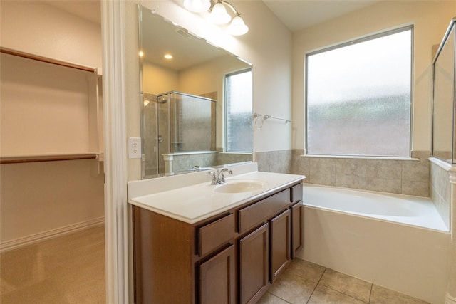 bathroom with tile patterned floors, a garden tub, vanity, and a shower stall