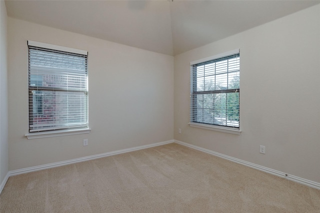 carpeted spare room with baseboards