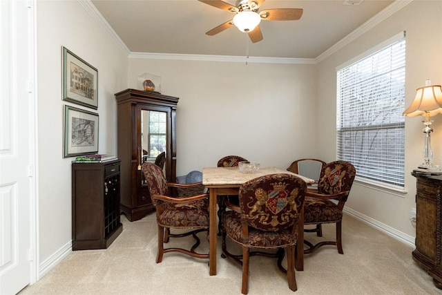 dining area featuring light carpet, crown molding, and baseboards