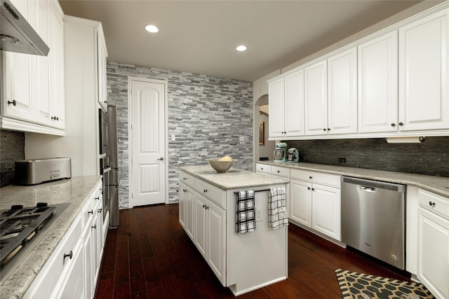 kitchen with dark wood finished floors, recessed lighting, white cabinets, appliances with stainless steel finishes, and tasteful backsplash