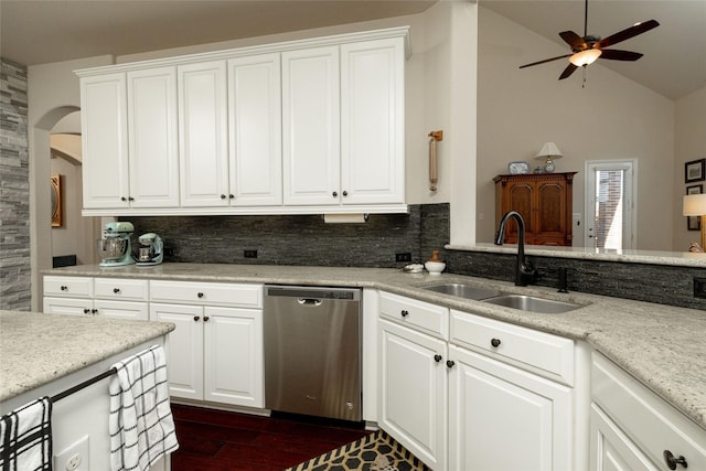 kitchen featuring a sink, decorative backsplash, vaulted ceiling, dark wood-type flooring, and dishwasher