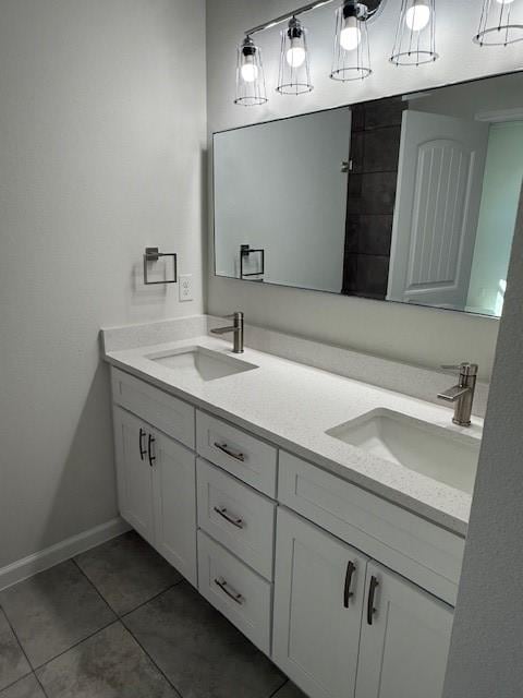 bathroom with tile patterned flooring, a sink, and double vanity