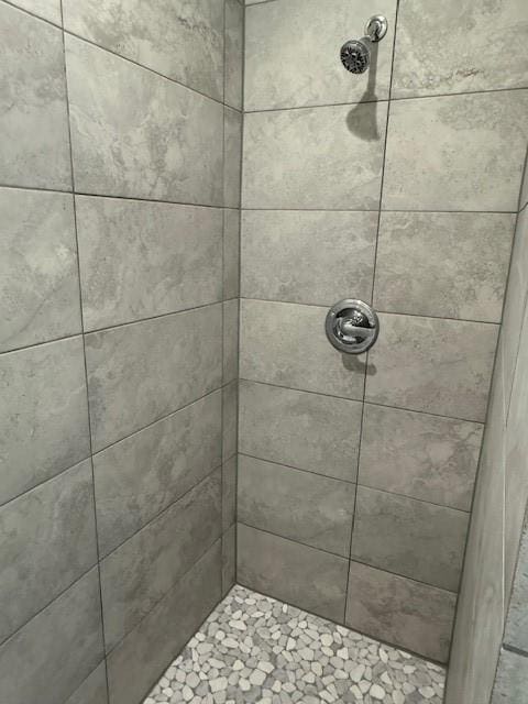 full bath with a tile shower