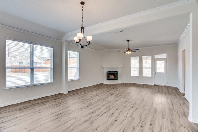 unfurnished living room featuring baseboards, visible vents, a fireplace with raised hearth, ornamental molding, and light wood-style floors