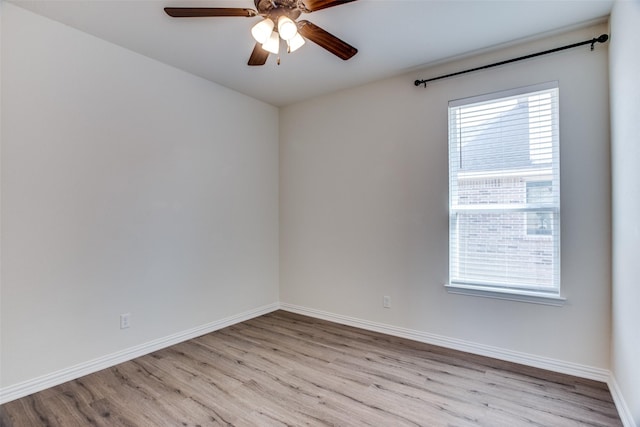 empty room with light wood finished floors, ceiling fan, and baseboards