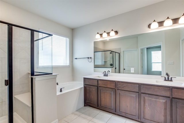 bathroom featuring a garden tub, a sink, a shower stall, and double vanity