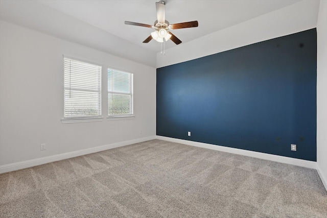 unfurnished room featuring carpet, ceiling fan, and baseboards