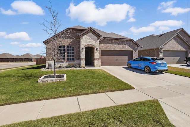 french country home featuring stone siding, brick siding, concrete driveway, and a front yard