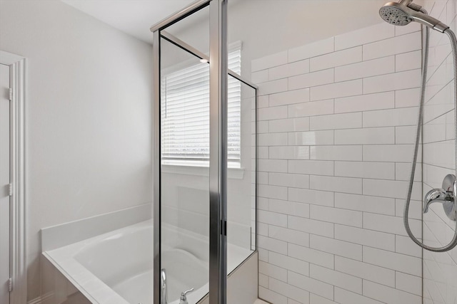 full bathroom featuring a shower stall and a washtub