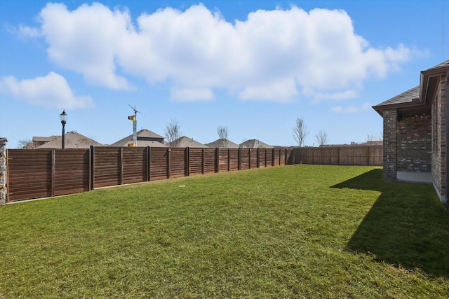 view of yard with a fenced backyard