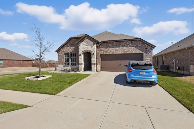 french provincial home with brick siding, stone siding, a front lawn, and driveway