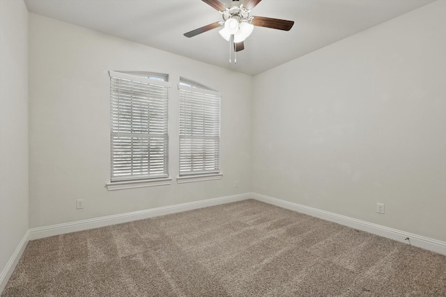 unfurnished room with carpet flooring, a ceiling fan, and baseboards