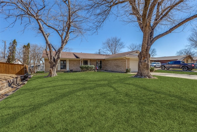 ranch-style home with an attached garage, brick siding, fence, driveway, and a front yard