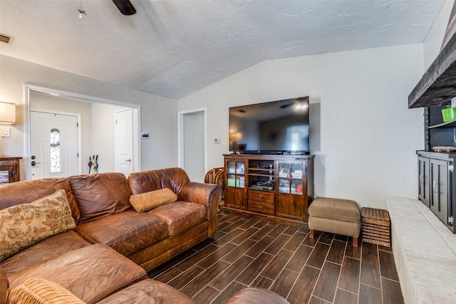 living room with lofted ceiling, wood finish floors, and visible vents