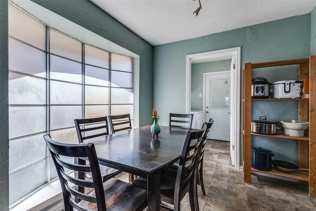 dining space featuring stone finish floor