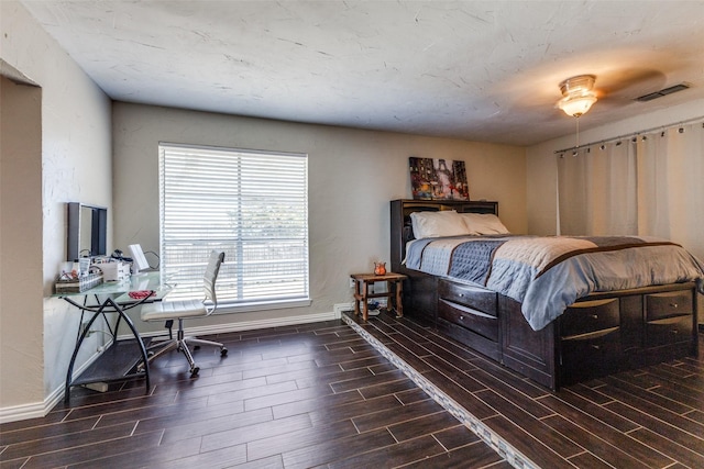 bedroom with wood tiled floor, visible vents, and baseboards