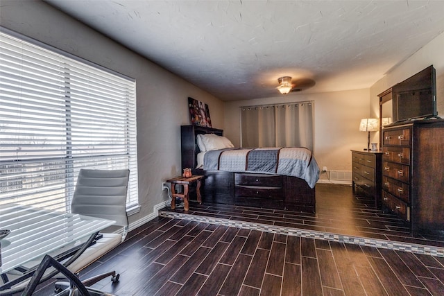 bedroom with wood finish floors and baseboards