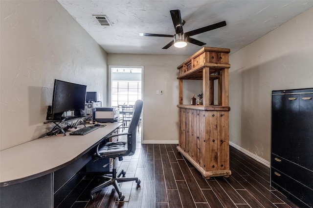 home office featuring baseboards, a ceiling fan, visible vents, and wood tiled floor