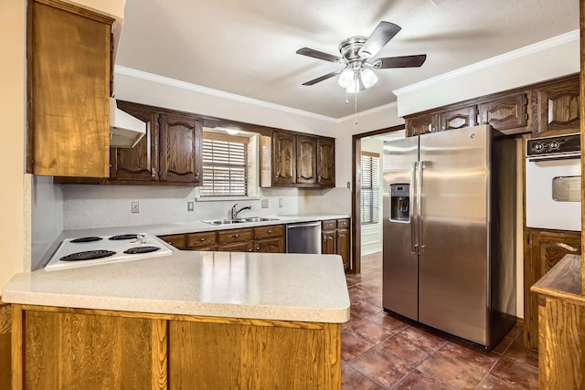 kitchen with range hood, stainless steel appliances, crown molding, light countertops, and a sink